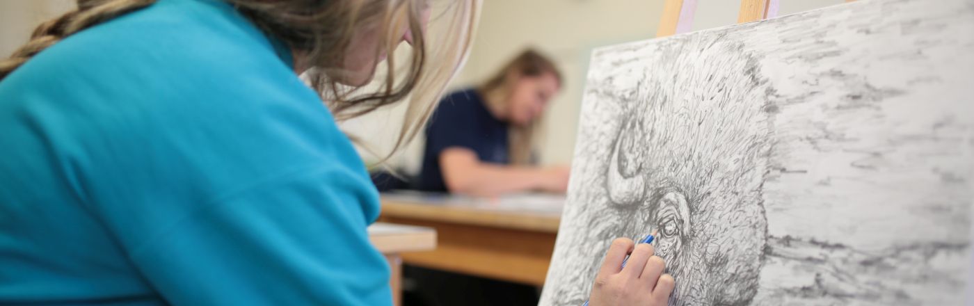Student drawing in an art class
